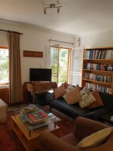 a living room with a couch and a coffee table at Loveable Karoo Cottages in Fraserburg