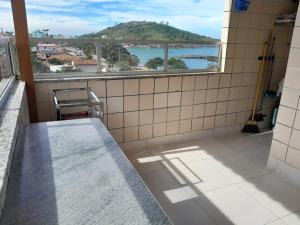 a bathroom with a view of the ocean from a balcony at Apartamento com vista para o mar em Setiba Guarapari in Guarapari
