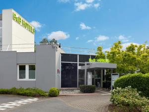 a gas station with a sign on top of it at B&B HOTEL Cergy Port 4 étoiles in Cergy