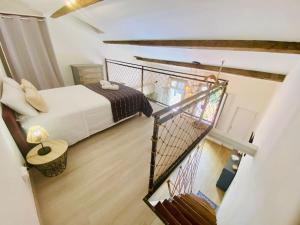a view of a bedroom with a bed and a staircase at Suzon Petit loft Terrasse et Clim Coté Mairie in Sète