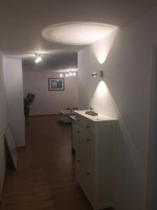 a hallway with a white room with a light on the ceiling at Peter's Ferienwohnung Nahe Rust, Kehl, Straßburg, Offenburg in Neuried