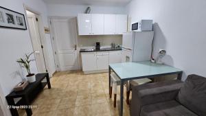 a small living room with a table and a kitchen at Puerto Rico Top Teide and Amadores View in Puerto Rico de Gran Canaria