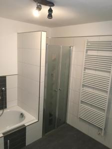 a bathroom with a shower and a sink and a tub at Peter's Ferienwohnung im Souterrain in Neuried
