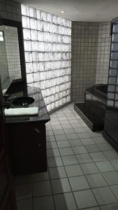 a bathroom with a toilet and a sink and a mirror at Pousada Trip Inn Recife in Recife +27 photos