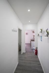 um quarto vazio com paredes brancas e um corredor em Capodichino Apartment 127 - 20 em Nápoles