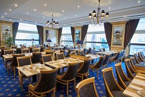 a dining room with tables and chairs and windows at JW Marriott Hotel Berlin in Berlin