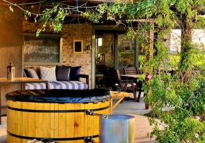 a patio with a couch and a wine barrel at Libertas Guest Farm in Hoekwil