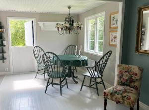 une salle à manger avec une table et des chaises vertes dans l'établissement Stuga i Vomb, à Veberöd