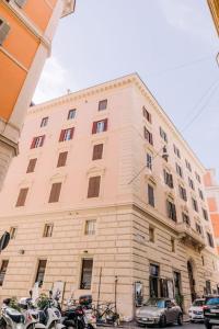a large building with motorcycles parked in front of it at Domus Quirinale in Rome