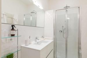 a white bathroom with a sink and a shower at Domus Quirinale in Rome +54 photos