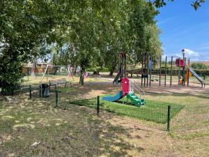 a park with a playground with slides and swings at Entre bassin et forêt in La Teste-de-Buch +3 photos
