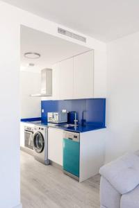 a kitchen with a washer and a washing machine at Marejada Coastal Suite in Puertito de Güímar