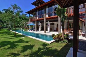 an exterior view of a house with a swimming pool at Villa Rumah Isah in Candidasa