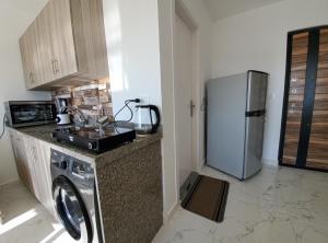 a kitchen with a washing machine and a refrigerator at Hurghada Pearl in Hurghada