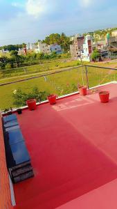 a red roof with potted plants on top of it at Kailash Guest Home in Mysore