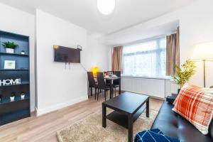 a living room with a couch and a table at 2-Bedroom Apartment in Greater London: Explore and Relax in Enfield