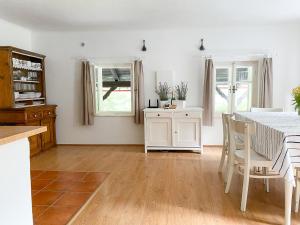 a kitchen and dining room with a table and chairs at Chaloupka v Českém Ráji in Semily