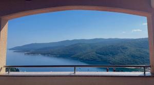 a view of a lake from a window at Apartments Silmare in Rabac