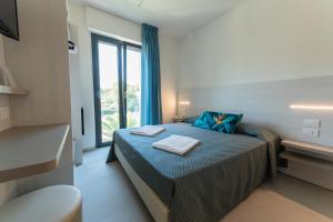 Postel nebo postele na pokoji v ubytování Hotel La Bussola + 37 fotografií