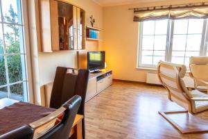 a living room with a dining table and a television at Holiday Home Blu Hus in Freest