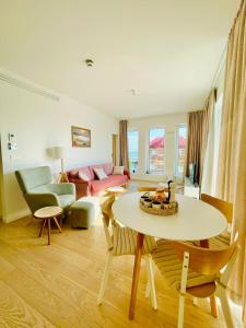 a living room with a couch and a table at Apartament Marina View in Darłowo