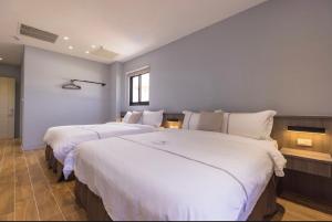A bed or beds in a room at Penghu Swing Sea Homestay