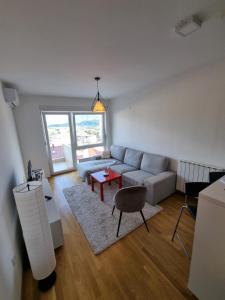 a living room with a couch and a table at Makovi Flat in Zenica