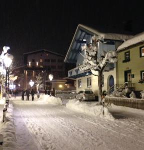 a street covered in snow at night with buildings at St Anton Apartment QX3 in Sankt Anton am Arlberg