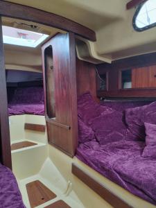 a room with purple bunk beds on a boat at Valkirja in Klaipėda