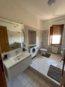 a bathroom with a sink and a washing machine at Il giardino degli Ulivi house in Ortona