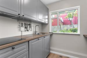 a kitchen with a sink and a window at Reykjavík Central Guesthouse in Reykjavík