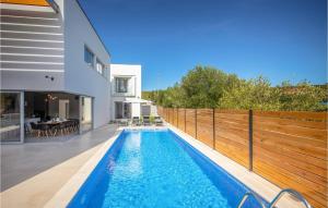 a swimming pool in the backyard of a house at Villa Activia in Sveti Filip i Jakov