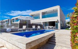 a villa with a swimming pool and a house at Villa Calla in Petrcane