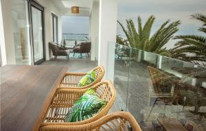 a balcony with a table and chairs on a patio at Villa Sunset Loft in Vir