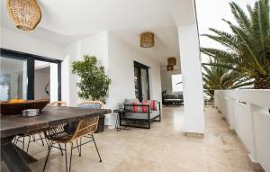 a living room with a wooden table and chairs at Villa Sunset Loft in Vir