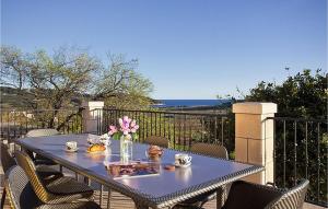 a blue table with a vase of flowers on a balcony at Villa Mar in Lumbarda +15 photos