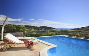 a swimming pool with a chaise lounge and a swimming pool at Villa Mar in Lumbarda
