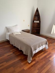 a bedroom with a bed and a wooden floor at Kuća Jelena in Veliki Prolog