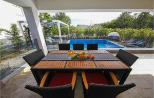 a wooden table with a bowl of fruit on a patio at Villa Angelina in Nin