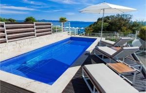 a swimming pool with two chairs and an umbrella at Villa Lantana in Petrcane +39 photos