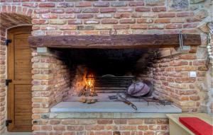 a brick oven with a fire inside of it at Villa Ambar in Škabrnje