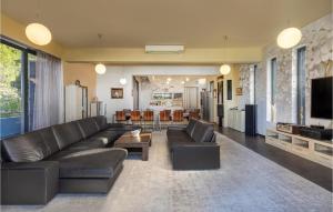 a living room with a leather couch and a television at Villa Bella in Mrljane