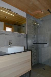 a bathroom with a sink and a shower at Chalet Loan in Montgenèvre
