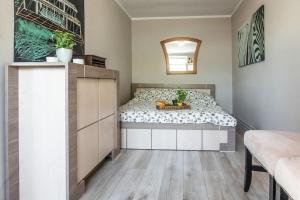 a bedroom with a bed with a table and a mirror at Domek Gościnny Czempion in Strzałkowo