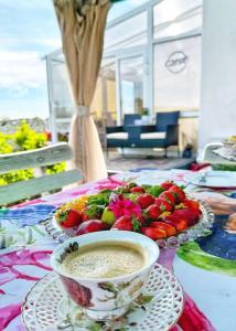 a table with a bowl of dip and a plate of fruit at Domek Gościnny Czempion in Strzałkowo