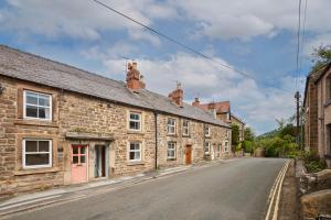 an empty street in a village with stone houses at Church View Cottage & Secret Garden, Matlock - Now Hosted by StayHostSave in Matlock