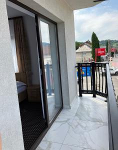 a sliding glass door to a balcony with a view at PENSIUNEA KONFORT in Borsa