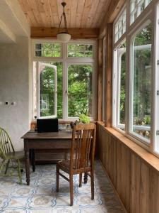 an office with a wooden desk with a laptop on it at Niebieski Koń in Kazimierz Dolny