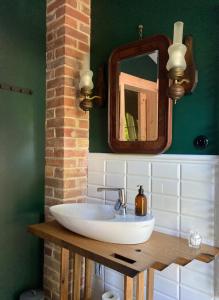a bathroom with a sink and a mirror at Niebieski Koń in Kazimierz Dolny