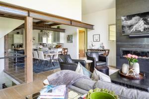 a living room with a couch and a dining room at Gray Owl Retreat in Big Sky